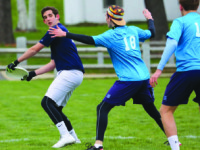 Captain Ben Wishnie-Edwards ’16 prepares to huck the disc downfield past two Hotchkiss defenders.