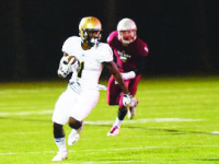 Hunter Reynolds cradles the ball as he dodges a defender.