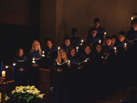Clothed in blue robes, choral students perform for an excited audience.. Andrew Garver / The Choate News.