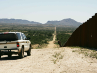 American agents patrol the Mexican border alongside an existing border wall. The United States Department of Homeland Security is responsible for monitoring the borders.