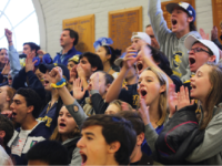 The Choate fan section cheers on Girls Varsity Volleyball on Deerfield Day.