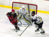 Defenseman Kyle Sanborn ’19 and goaltender Jackson Elkins ’18 follow a puck out of the zone.